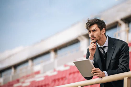 A man with a tablet thinking about strategy