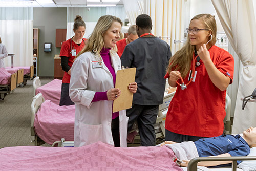 A nursing student learning with an instructor