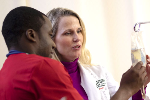A nursing student setting up an IV
