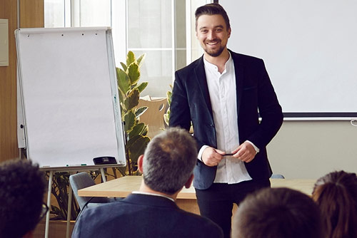 A man giving a presentation to a group of office workers