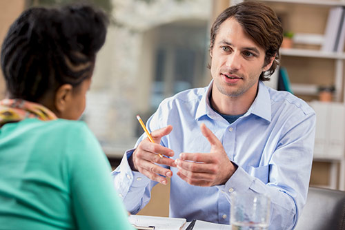 A man counseling a woman in an office