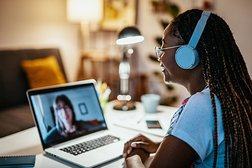 A woman having a virtual meeting in her home