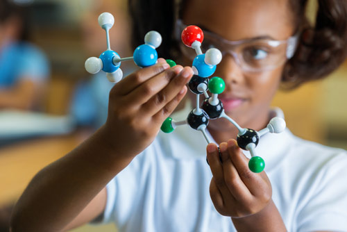A child holding a molecular model